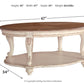 Realyn - White / Brown - Oval Cocktail Table